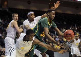 Baylor's Quincy Miller, center, scrambles for a loose ball against West Virginia's Jabarie Hinds, rear, and Kevin Jones (4) in the second half of an NCAA college basketball game, Friday, Dec. 23, 2011, in Las Vegas. Baylor won 83-81 in overtime. (AP Photo/Julie Jacobson)