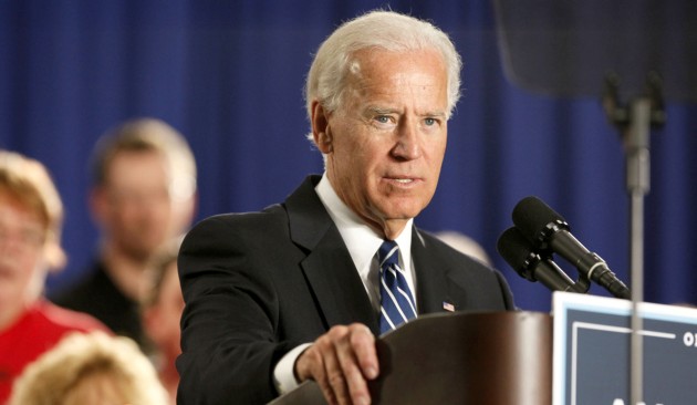 Biden defends Obama, challenges Romney