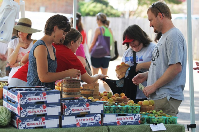 Waco residents pay for goods sold by other Waco residents at the Downtown Farmer's Market. Photo credit: Lariat file photo 