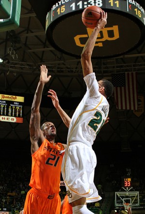 No. 21 center Isaiah Austin leaps up over OSU No. 21 forward Kamari Murphy to shoot for two points in the Ferrell Center on Monday, Jan. 21, 2013.  The Bears celebrated a 64-54 victory over the Cowboys.

Matt Hellman | Lariat Photo Editor