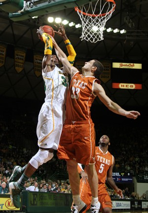 No. 34 forward Cory Jefferson attempts to perform a lay up for two points while being defended by Texas No. 33 forward Ioannis Papapetrou during the first half of the matchup on Saturday, Jan. 5, 2013, in the Ferrell Center. The Bears defeated the Longhorns 86-79 in overtime.Matt Hellman | Lariat Photo Editor