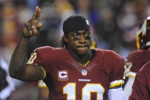 Washington Redskins quarterback Robert Griffin III salutes the crowd as he walks off the field with a twisted knee during the second half of a playoff football game Sunday against the Seattle Seahawks. Washington lost the game. (AP Photo/Richard Lipski)