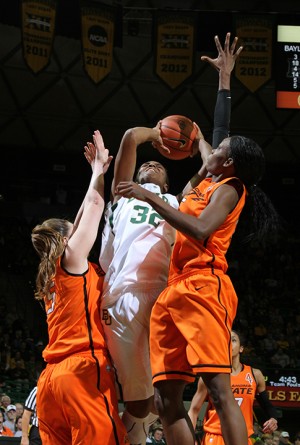 No. 32 forward Brooklyn Pope shoots for two points while under double coverage by OSU No. 25 center Lindsey Keller and No. 15 forward Toni Young in the Ferrell Center on Sunday, Jan. 6, 2013. Pope led the Lady Bears in their 83-49 victory over the Cowgirls with 18 points.Matt Hellman | Lariat Photo Editor