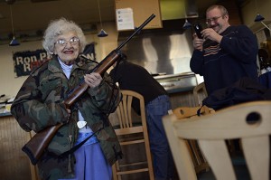 Lee Lazernick, right, asked his mother Thelma Lazernick, left, to pose with a customer's Ruger Mini-14 .223 semi-automatic rifle on Monday, Feb. 18, 2013, at All Around Pizza and Deli in Virginia Beach, Va., where customers wearing weapons or who bring their concealed weapons permit are offered a 15 percent discount. (AP Photo/The Virginian-Pilot, Amanda Lucier) MAGS OUT