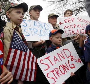 Clockwise from left,  Boy Scouts Eric Kusterer, Jacob Sorah, James Sorah, Micah Brownlee and Cub Scout John Sorah hold signs at the Save Our Scouts Prayer Vigil and Rally in front of the Boy Scouts of America National Headquarters in Irving, Texas, Wednesday, February 6, 2013.  The Boy Scouts of America said Wednesday it needed more time before deciding whether to move away from its divisive policy of excluding gays as scouts or adult leaders.  Associated Press