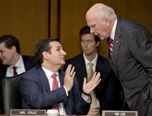 FILE - In this Jan. 30, 2013 file photo Senate Judiciary Committee member Sen. Ted Cruz, R-Texas, left, talks with committee Chairman Patrick Leahy, D-Vt., during a hearing about gun violence on Capitol Hill in Washington. Weeks into his job, Texas Republicans are cheering Cruz's indelicate debut and embracing him as one of their own. The insurgent Republican elected with the tea party's blessing and bankroll, has run afoul of GOP mainstays, prompted Democrats to compare his style to McCarthyism. (AP Photo/J. Scott Applewhite, File)