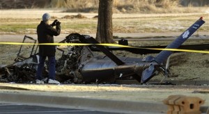 Investigators with the FAA look over the wreckage of a medical helicopter which crashed Friday, Feb. 22, 2013 in front of the Saint Ann Retirement Center in Oklahoma City, Okla. Two people were killed in the crash and a third person was injured.  (AP Photo/The Oklahoman,Paul Hellstern)