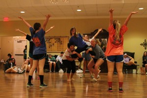 Kappa Alpha Theta practices the synchronized swimming stunts for their Olympics themed Sing act in their Chapter room.