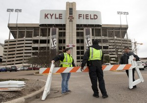 Texas A&M security personnel who wished not to be identified barricade the entrance to Kyle Field after a bomb threat Wednesday Feb. 20, 2013 in College Station, Texas. Texas A&M University is investigating a bomb threat at Kyle Field that prompted the school to issue a "code maroon" safety advisory and close the stadium and nearby buildings. (AP Photo/ Patric Schneider)