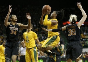 Texas' Imani McGee-Stafford (34) and Brady Sanders (32) defend as Baylor guard Odyssey Sims, center, goes up for a a score in the second half of an NCAA college basketball game Saturday, Feb. 23, 2013, in Waco, Texas. Sims had 15-points in the 67-47 Baylor win. (AP Photo/Tony Gutierrez)