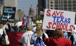 Teachers, students, parents and school administrators march up Congress Avenue as they take part in a rally for Texas public schools at the state Capitol, Saturday, Feb. 23, 2013, in Austin, Texas. About 2,000 teachers, students, parents and school administrators rallied at the state Capitol, demanding that the Legislature reverse $5.4 billion in cuts to public education amid new data that Texas now spends less per-pupil than almost anywhere else in America. (AP Photo/Eric Gay)