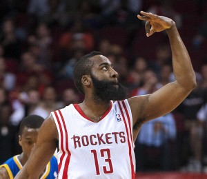 Houston Rockets' James Harden signals to the crowd after shooting a 3-point basket during the first quarter of an NBA basketball game against the Golden State Warriors, Tuesday, Feb. 5, 2013, in Houston. (AP Photo/Dave Einsel)