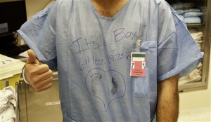 In this photo provioded by Womenís Memorial Hermann Hospital, a new father signals thumbs up after his wife delivered a baby boy Wednesday, Feb. 20, 2013 in Houston, Texas. A routine cesarean section delivery at the Houston hospital went live with the surgery on Twitter on Wednesday, broadcasting snippets of information along with graphic pictures and video, part of a growing and ever more popular trend as hospitals and doctors hungry for clients use social media to promote their services. This photo was posted on its Twitter feed during the surgery. The patient and her family members were not identified in the Twitter feed. (AP Photo/Women's Memorial Hermann Hospital)