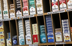 Cigarette packs are displayed at a convenience store in New York, Monday, March 18, 2013. A new anti-smoking proposal would make New York the first city in the nation to keep tobacco products out of sight in retail stores. Mayor Michael Bloomberg says the goal is to reduce the youth smoking rate. The legislation would require stores to keep tobacco products in cabinets, drawers, under the counter, behind a curtain or in another concealed spot. They could only be visible when an adult is making a purchase or during restocking. (AP Photo/Mark Lennihan)