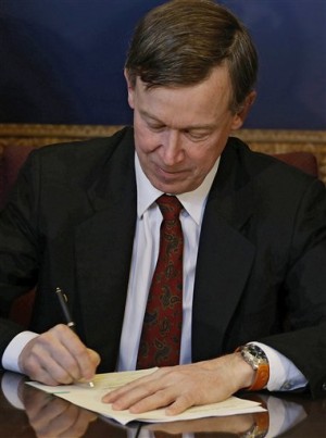 Colorado Gov. John Hickenlooper signs the state's gun control bills into law at the Capitol in Denver on Wednesday, March 20, 2013. The bills place new restrictions on firearms and signal a change for Democrats who traditionally shied away from the gun control debate in Colorado. (AP Photo/Ed Andrieski, Pool)