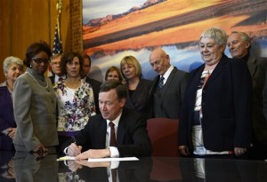 Colorado Governor John Hickenlooper signs  gun control measures in his office at the state capitol, March, 20, 2013, in Denver. The bills require background checks for private and online gun sales and ban ammunition magazines that hold more than 15 rounds. (Photo By RJ Sangosti/The Denver Post, RJ Sangosti, Pool)
