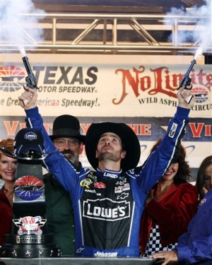 FILE - In this Nov. 4, 2012, file photo, Jimmie Johnson fires blanks out of a pair of revolvers as he celebrates his win in Victory Lane following the NASCAR Sprint Cup Series auto race at Texas Motor Speedway, in Fort Worth, Texas. The National Rifle Association is taking its relationship with racing to a new level as the title sponsor of a NASCAR Sprint Cup Series race. The deal with Texas Motor Speedway comes at a time when the NRA is involved in a renewed debate on gun violence in the wake of the December shooting at Sandy Hook Elementary School in Newtown, Conn. (AP Photo/Tim Sharp, File)