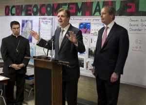 FILE - In this Dec. 19, 2012 file photo, Texas Senate Education Chairman Dan Patrick, center, speaks during a visit to the Cathedral School of Saint Mary in downtown Austin, Texas, as Lt. Gov. David Dewhurst, right, and Bishop Oscar Cantu listen. Patrick is on a crusade to reshape Texas classrooms in the name of school choice, pushing for the states largest expansion of charter schools and touting an ambitious voucher plan that would allow students to attend private schools with public money. (AP Photo/Statesman.com, Ralph Barrera, File)