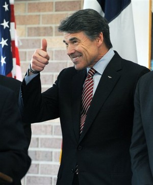 Texas Gov. Rick Perry gives a "thumbs-up" gesture to a member of the audience during a ceremony Thursday, Feb. 28, 2013, at Stephen F. Austin State University in Nacogdoches, Texas. (AP Photo/The Daily Sentinel, Andrew D. Brosig)