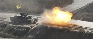 A South Korean army K1 tank fires live rounds during an exercise at Seungjin Fire Training Field in mountainous Pocheon, South Korea, near the border with North Korea, Wednesday, March 27, 2013. North Korea said Wednesday that it had cut off a key military hotline with South Korea that allows cross border travel to a jointly run industrial complex in the North, a move that ratchets up already high tension and possibly jeopardizes the last major symbol of inter-Korean cooperation.(AP Photo/Yonhap, Lim Byung-shick)