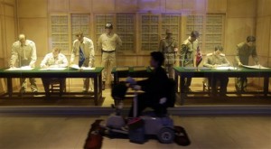 A cleaner rides a cart in front of an exhibit depicting the 1953 cease-fire agreement of the Korean War at the Korea War Memorial Museum in Seoul, South Korea, Wednesday, March 6, 2013. North Korea's military is vowing to cancel the 1953 cease-fire that ended the Korean War, straining already frayed ties between Washington and Pyongyang as the United Nations moves to impose punishing sanctions over the North's recent nuclear test. (AP Photo/Lee Jin-man)