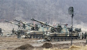 South Korean soldiers work on their K-9 self-propelled artillery vehicles during an exercise against possible attacks by North Korea near the border village of Panmunjom in Paju, South Korea, Thursday, March 7, 2013. North Korea vowed Tuesday to cancel the 1953 cease-fire that ended the Korean War, citing a U.S.-led push for U.N. sanction over its recent nuclear test and ongoing U.S.-South Korean joint military exercise.  (AP Photo/Ahn Young-joon)