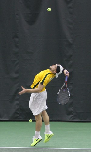 Szeged, Hungary sophomore Mate Zsiga surves the ball in his singles match at the Jim and Nell Hawkins Indoor Tennis Center on Saturday, Feb. 9, 2013.  The team ended up walking away with a 6-1 victory over Purdue. Travis Taylor | Lariat Photographer