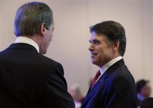 Gov. Rick Perry, right, Talks with Lt. Gov. David Dewhurst, left, prior to his address to the Texas Business Leadership Council, Tuesday, Feb. 26, 2013, in Austin, Texas. Perry says he supports taking a hard look at the 15 standardized tests Texas high school students are currently required to take for graduation. (AP Photo/Eric Gay)