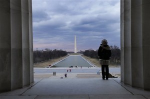 This Feb. 28, 2013 photo shows a visitor viewing the National Mall from the Lincoln Memorial looking towards the Washington Monument and the U.S. Capitol in Washington. There are probably more free things to do in the U.S. capital than nearly any other major city in the world. The most popular museums and the zoo are free, thanks to government funding, as well as the picturesque memorials and monuments. With so many free options, the biggest challenge might be narrowing down what to see.   (AP Photo/Alex Brandon)