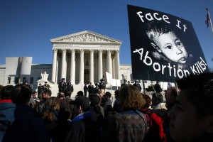 Anti-abortion protestors march in front of the Supreme Court Tuesday, January 22, 2002, the anniversary of the court's Roe v. Wade decision that legalized abortion.  (Chuck Kennedy | McClatchy Newspapers)