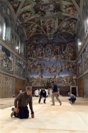 This photo provide by the Vatican newspaper L'Osservatore Romano shows workers putting floor boards on the ground inside the Sistine Chapel, at the Vatican, Friday, March 8, 2013.  Cardinals have set Tuesday March 12 as the start date for the conclave to elect the next pope, signaling that they were wrapping up a week of discussions about the problems of the church and who best among them might lead it. The conclave date was set on Friday afternoon during a vote by the College of Cardinals. Tuesday will begin with a Mass in the morning in St. Peter's Basilica, followed by the first balloting in the Sistine Chapel in the afternoon. (AP Photo/L'Osservatore Romano, ho)