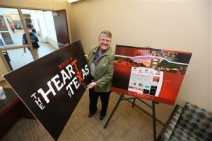 Tourism chief Liz Taylor holds up materials with the new Heart of Texas logo, part of a regional marketing strategy to define the image of Greater Waco and attract more visitors. (Waco Tribune-Herald)