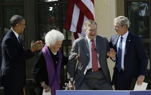 As President Barack Obama, left, applauds, former first lady Barbara Bush, second from left, and former president George W. Bush right, help forer president George H.W. Bush stand to acknowledge a standing ovation during the dedication of the George W. Bush Presidential Center Thursday, April 25, 2013, in Dallas.(AP Photo/David J. Phillip)
