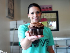 What About Cupcakes? store owner Holly Harris shows off one of her chocolate cupcakes.  The second What About Cupcakes? store is located on 1400 Speight Avenue.  Travis Taylor | Lariat Photographer
