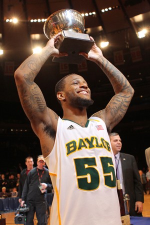 Pierre Jackson, No. 55, hoists the NIT Most Outstanding Player trophy after defeating the Iowa Hawkeyes 74-54 Thursday night. (Drew Mills | Round Up Photographer)