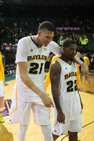 Freshman center Isaiah Austin walks off the court with senior guard A.J. Walton after Baylor’s NIT victory over Providence on March 27. (Matt Hellman | Lariat Photo Editor)