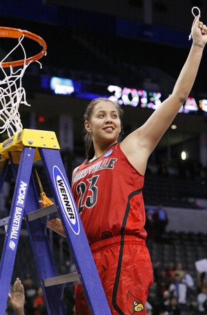Louisville’s Shoni Schimmel cuts down a piece of the net after her team defeated Tennessee during their regional final game Tuesday. (Alonzo Adams | Associated Press)