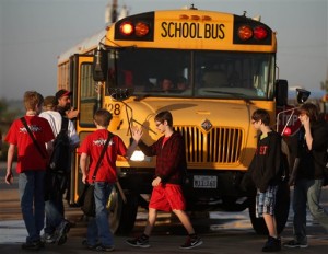 West high school students slaps hand before loading their buses to nearby Connally Independent School District Monday, Monday, April 22, 2013, in Waco, Texas. Several schools in West, Texas were damaged by the plant explosion killed  14 people and injured more than 160 others. (AP Photo/Waco Tribune Herald, Rod Aydelotte)