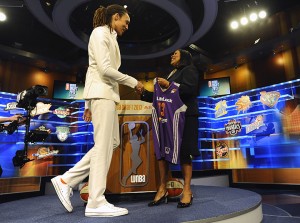 Brittney Griner, left, shakes hands with WNBA President Laurel J. Richie after the Phoenix Mercury selected Griner as the No. 1 pick in the WNBA basketball draft, Monday, April 15, 2013, in Bristol, Conn. (AP Photo/Jessica Hill)