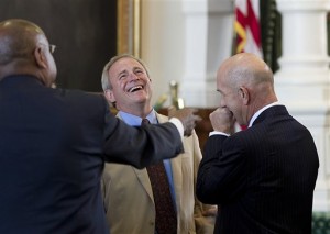 Michael Morton, left, and State Sen. John Whitmire share a laugh during ceremony in the Senate Chamber in which Morton was honored in Austin, Texas, Wednesday, March 13, 2013. Morton spent twenty-five years in prison after being wrongly convicted of killing his wife. (AP Photo/Austin American Statesman, Alberto Martínez)