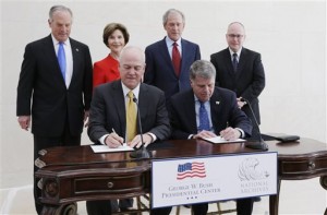 Bush Center president Mark Langdale, front left and national archivist David Ferriero, right, sign a joint use agreement for the George W. Bush Presidential Center Wednesday, April 24, 2013, in Dallas. At rear from left are board chairman of the George W. Bush Foundation Don Evans, former first lady Laura Bush, former president George W. Bush, and Bush Center Director Alan Lowe.  Bush and his wife, Laura, attended Wednesday's ceremony in Dallas the day before the official dedication of the George W. Bush Presidential Center. The George W. Bush Foundation raised the money to build the center. The foundation donated the library and museum portion of the center to the National Archives, which provides access to presidential records, documents, historical materials and artifacts over time. (AP Photo/David J. Phillip)