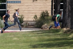 Students run from the Lone Star College's Cy-Fair campus in Cypress, Texas, where a student went on a building-to-building stabbing attack Tuesday, April 9, 2013. The attacker wounded at least 14 people before being subdued and arrested, authorities said. (AP Photo/Houston Chronicle, James Nielsen)