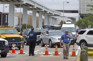 Airport security members divert traffic around the Marriott before getting to Terminal B at Bush Intercontinental Airport on Thursday, May 2, 2013 in Houston.   Shots were fired near a ticket counter, critically injuring one armed man and sending people in the terminal scrambling and screaming, a Houston police spokesman and witnesses said.   One person has been taken to an area hospital with life threatening injuries. It was not immediately clear who fired the shots.  (AP Photo/Houston Chronicle, Karen Warren )