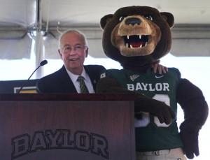 President Ken Starr stands at the podium with Bruiser as he speaks on the progress of Baylor's new football stadium on Tuesday, May 7, 2013, at the Simpson Athletics and Academic Center. Matt Hellman | Lariat Photo Editor