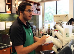 Miami, Fla., sophomore Julian LeFort works in the Starbuck’s located in Moody Library as part of the work-study program to help pay for his tuition. (Travis Taylor | Lariat Photographer)