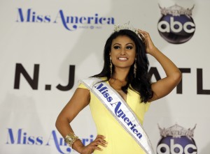 FILE - In this Sunday, Sept. 15, 2013 file photo, Miss America Nina Davuluri poses for photographers following her crowning in Atlantic City, N.J. For some who observe the progress of people of color in the U.S., Davaluri's victory in the Miss America pageant shows that Indian-Americans can become icons even in parts of mainstream American culture that once seemed closed. (AP Photo/Mel Evans)