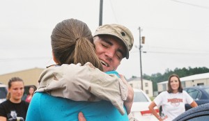 David Kaye, associate director of athletic communications, hugs his wife, Emily Kaye, after landing in Fort Polk, La., in fall 2006. He was first deployed with the Army Reserve in May 2005.  (Courtesy Photo)