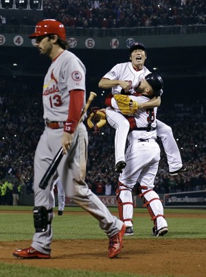 Boston Red Sox relief pitcher Koji Uehara and catcher David Ross celebrate after getting St. Louis Cardinals' Matt Carpenter to strike out and end Game 6 of baseball's World Series Wednesday, Oct. 30, 2013, in Boston. The Red Sox won 6-1 to win the series. (AP Photo/Matt Slocum)