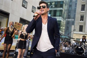 FILE - In this July 30, 2013 file photo, Robin Thicke performs on NBC's "Today" show in New York. The Recording Academy announced Wednesday, Oct. 8, 2013 that Drake, Robin Thicke and Macklemore & Ryan Lewis will perform at the Grammy Awards nominations special show Dec. 6 at the Nokia Theatre L.A. Live in Los Angeles.  The one-hour special will air live on CBS. (Photo by Charles Sykes/Invision/AP, File)