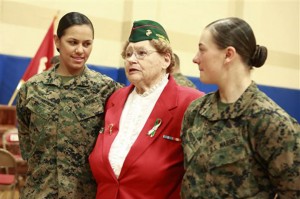 Private First Class  Cristina Fuentes Montenegro,left, 25, and Pfc. Julia Carroll,right, 18, share a moment with Shirley John, president, Women Marines Assiciation, NC-1, Tarheel Chapter, Jacksonville following graduation ceremony held on Camp Geiger, Jacksonville, Thursday, Nov. 21, 2013. Montenegro  and Carroll were two of the three female Marines who became the first women to graduate from the Corps' tough-as-nails enlisted infantry training school in North Carolina. The three completed the rigorous 59-day course and met the same test standards as the men, said Marine Corps spokeswoman Capt. Geraldine Carey. (AP Photo/The Daily News, John Althouse)